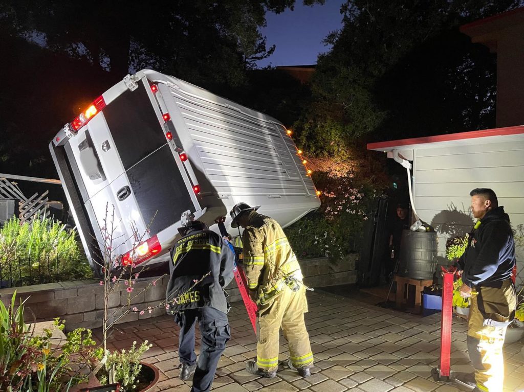 Van narrowly misses home after plummeting down embankment